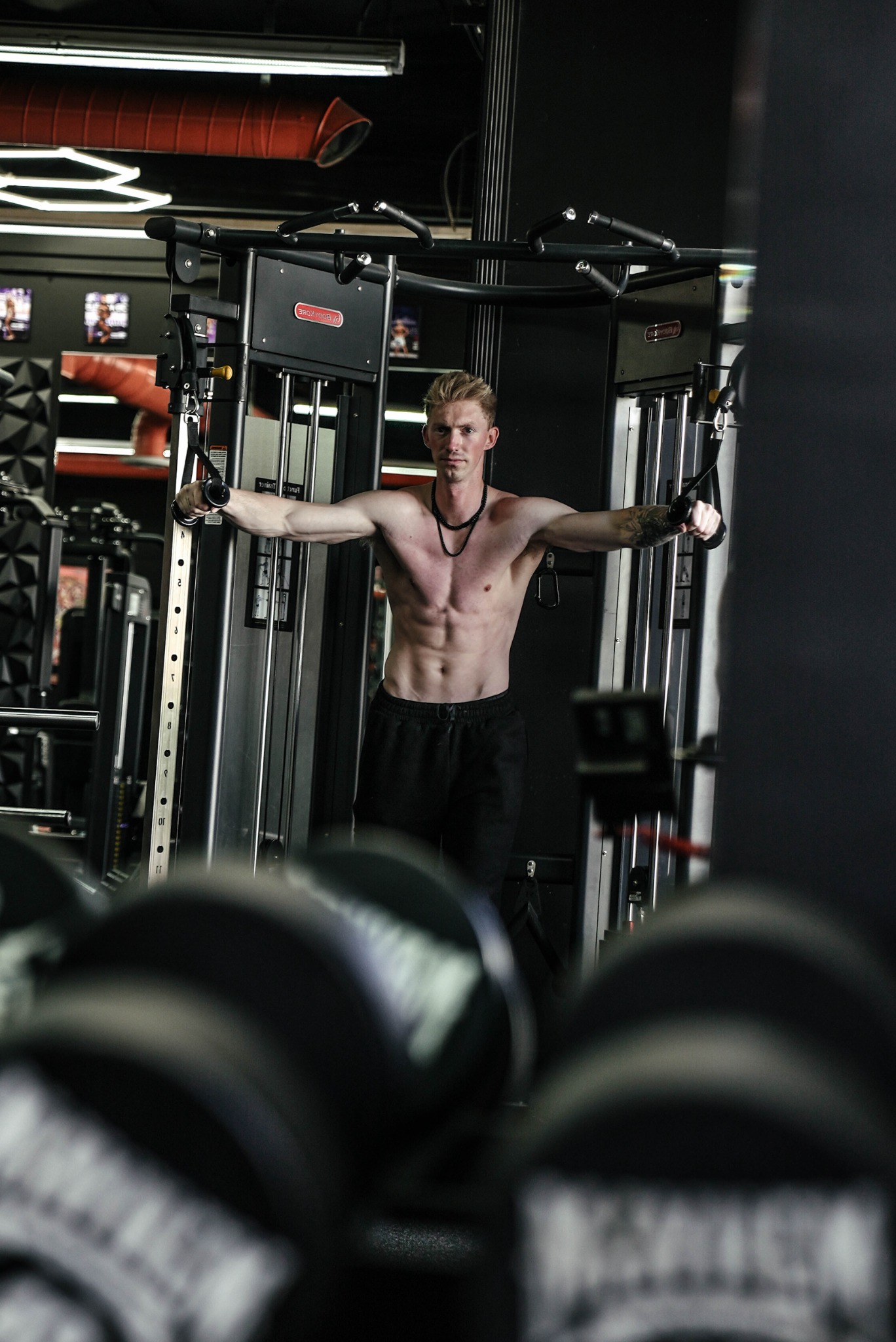 Parker training on a cable machine in the gym